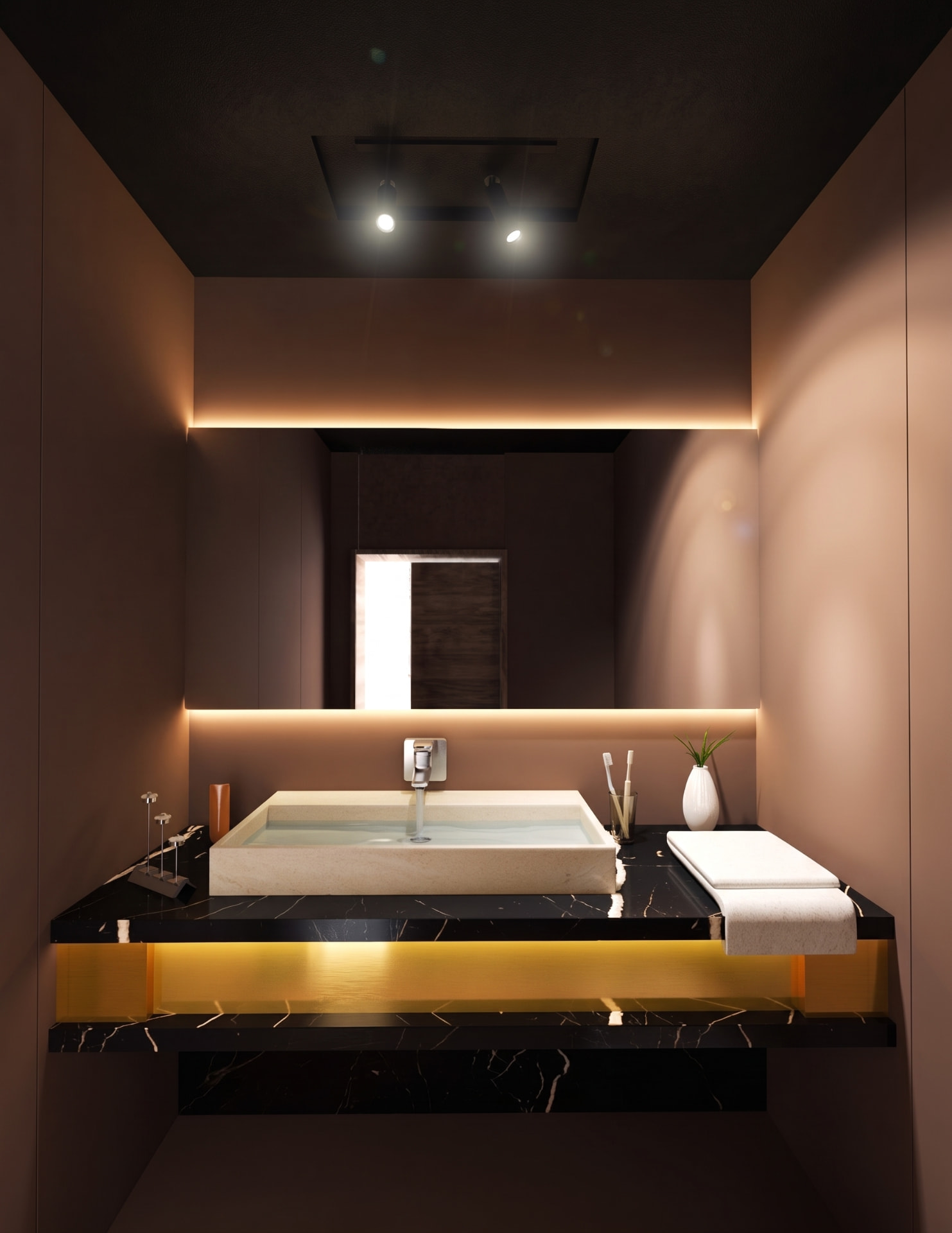 Dark bathroom with black marble counter, stone basin and golden concealed lighting